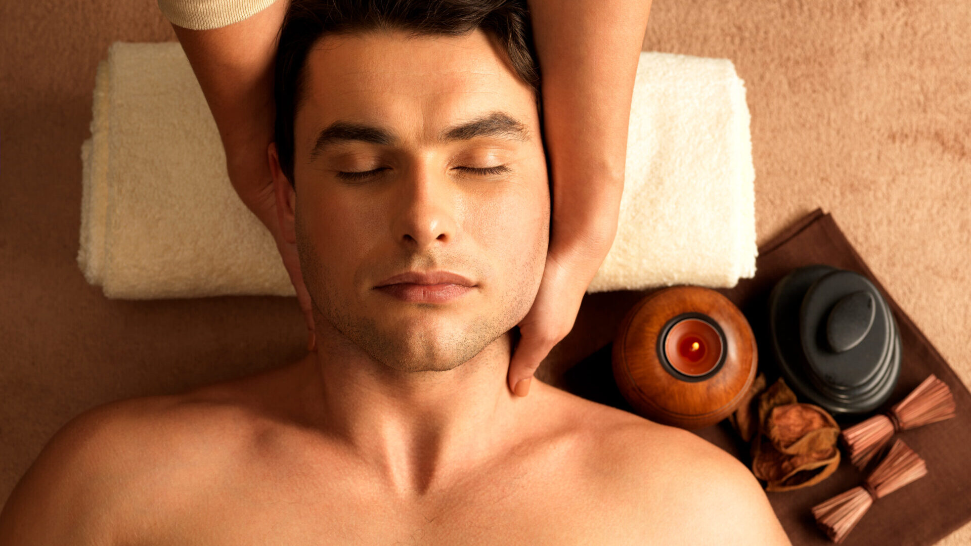 Masseur doing neck massage on man in the spa salon.